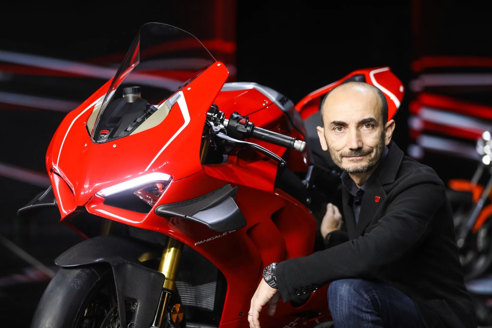 Ducati CEO Claudio Domenicali poses with the new Panigale V4 R at its EICMA launch event