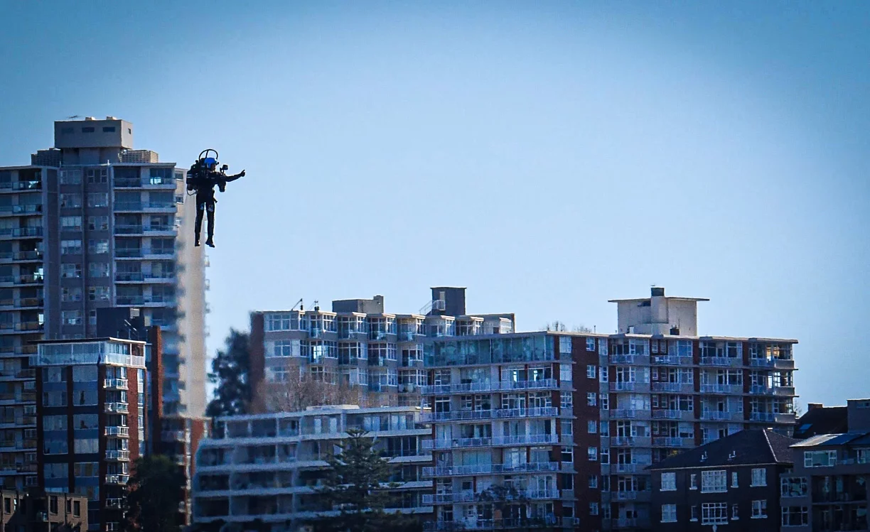 Mayman gives a thumbs-up to a hovering news helicopter out of frame