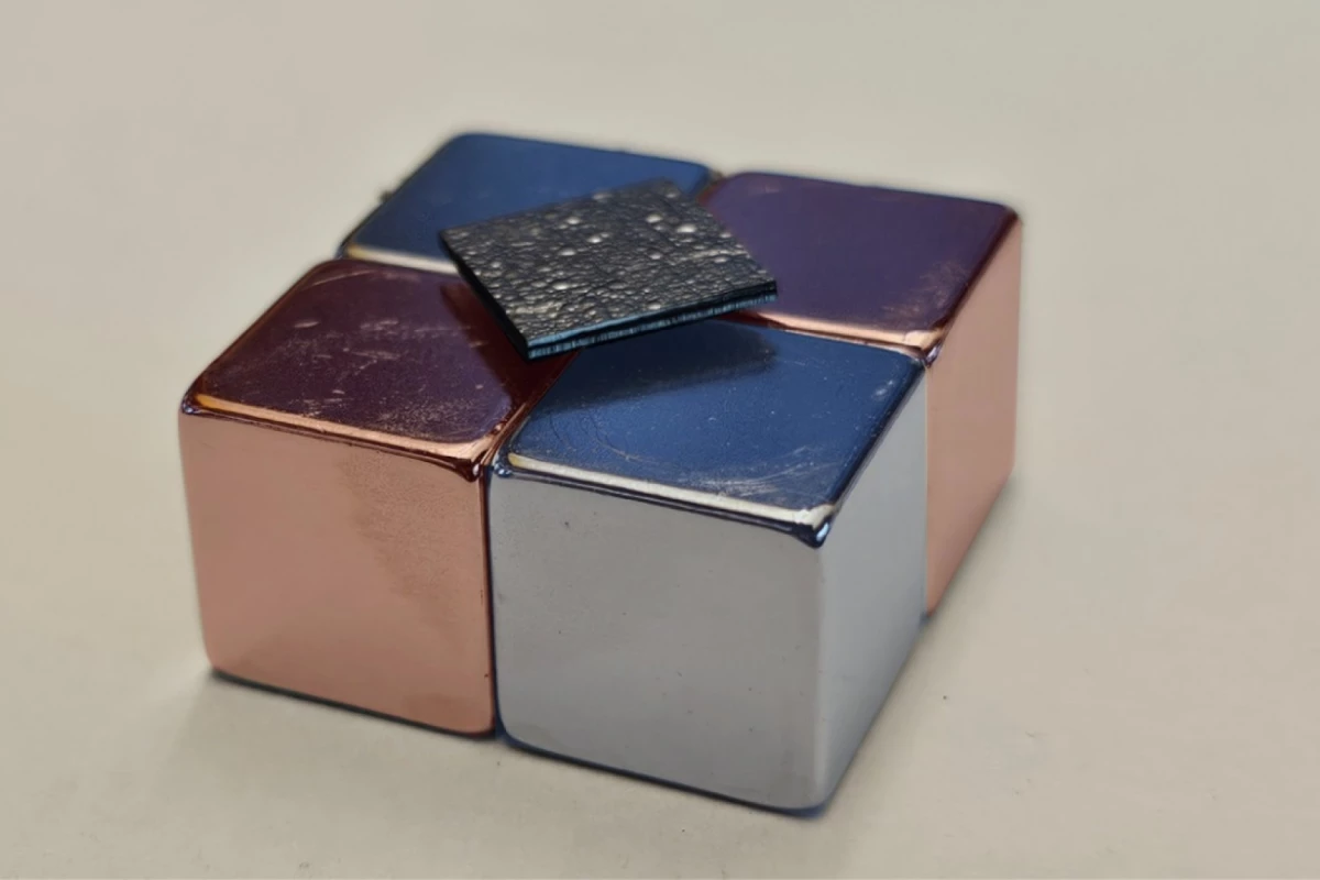 The silica-coated graphite plate levitates above a magnetic surface, with no need for external power