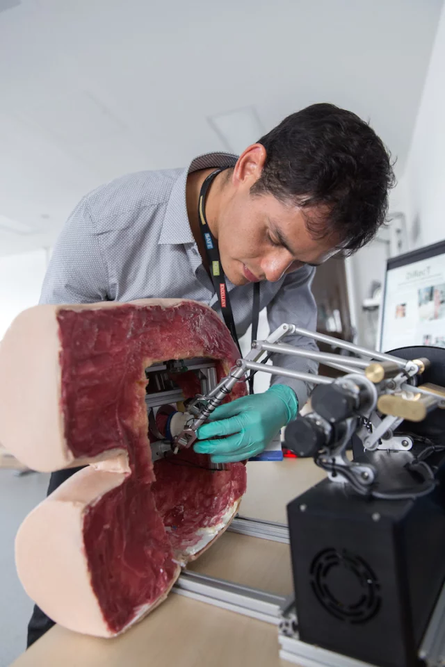 The user slips their finger into a silicone thimble, which is attached to small robotic arms that apply pressure to simulate the feel of healthy or potentially cancerous prostate glands
