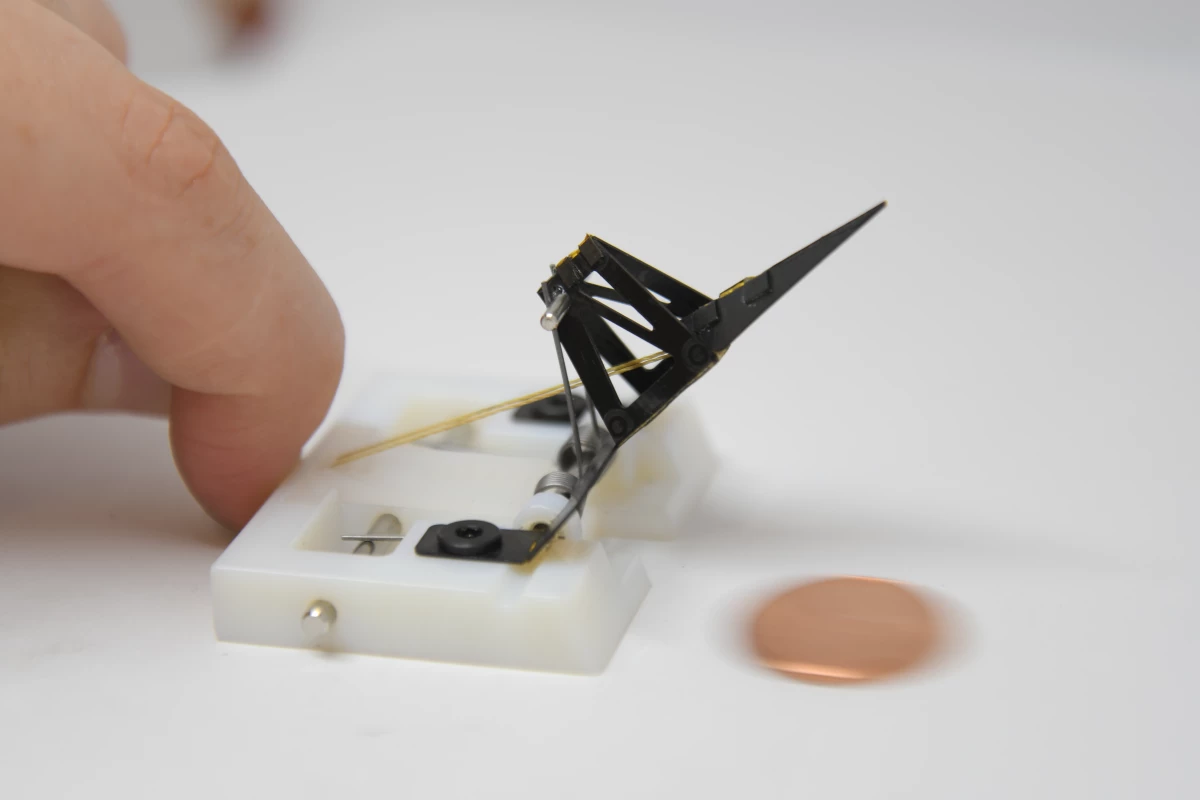 The arm of the robot (seen here flicking a penny) accelerates at the equivalent of "a car reaching 58 mph [93 km/h] in four milliseconds"