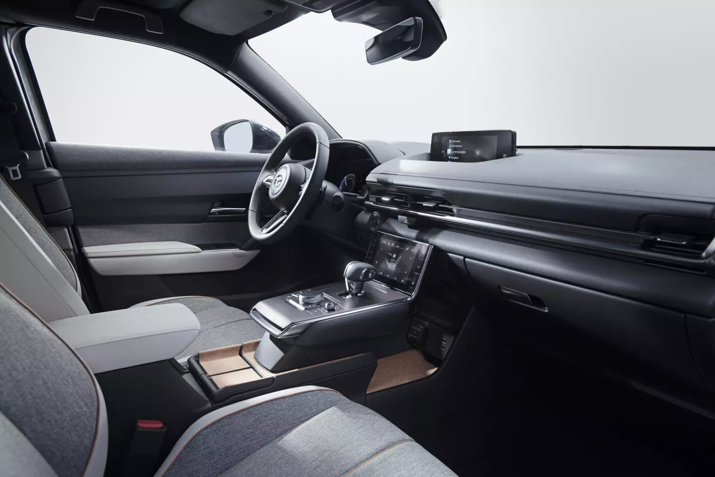 The simple dashboard in the MX-30 features two screens, one ahead of the shifter for climate controls, and one on top of the dash for infotainment