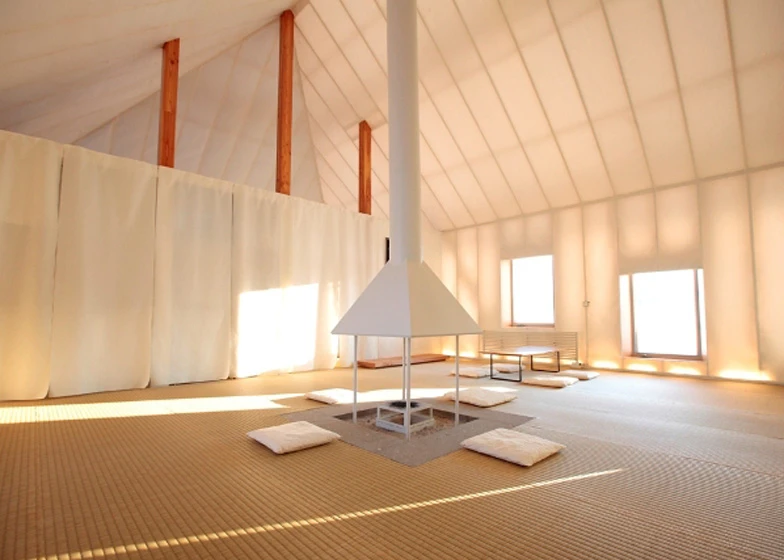 A central fireplace radiates heat throughout the entire space
