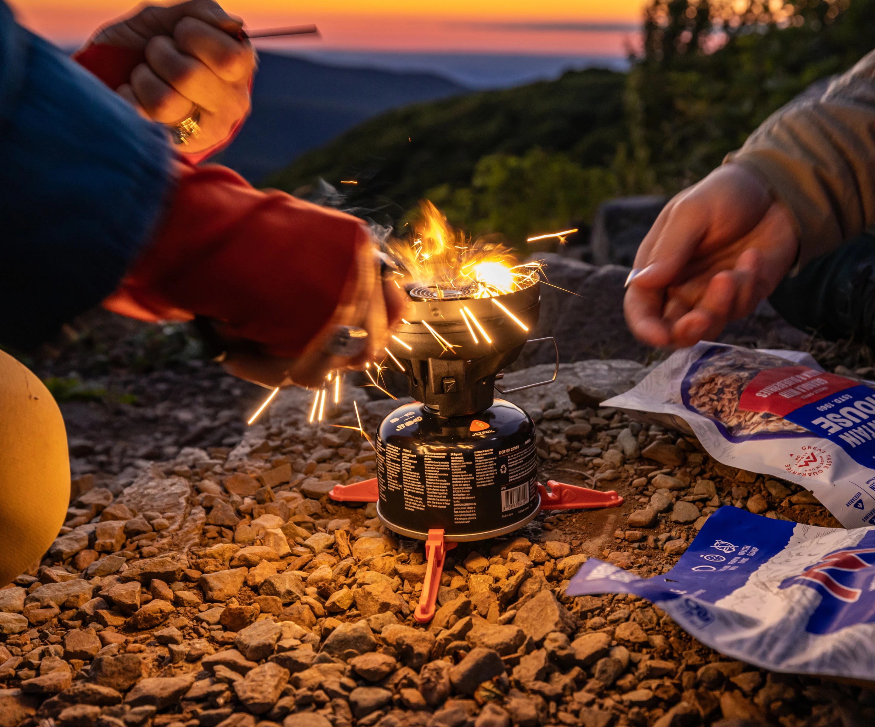 It won't always be a survival fire in the backcountry; here an adventurer uses the Gerber Stakeout Spark's fire-starting to light their backpacking stove