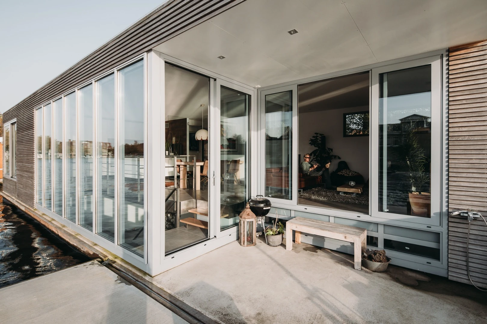 The floating home features a small outdoor terrace