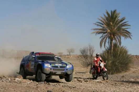 Saby passing a motorcycle in the desert