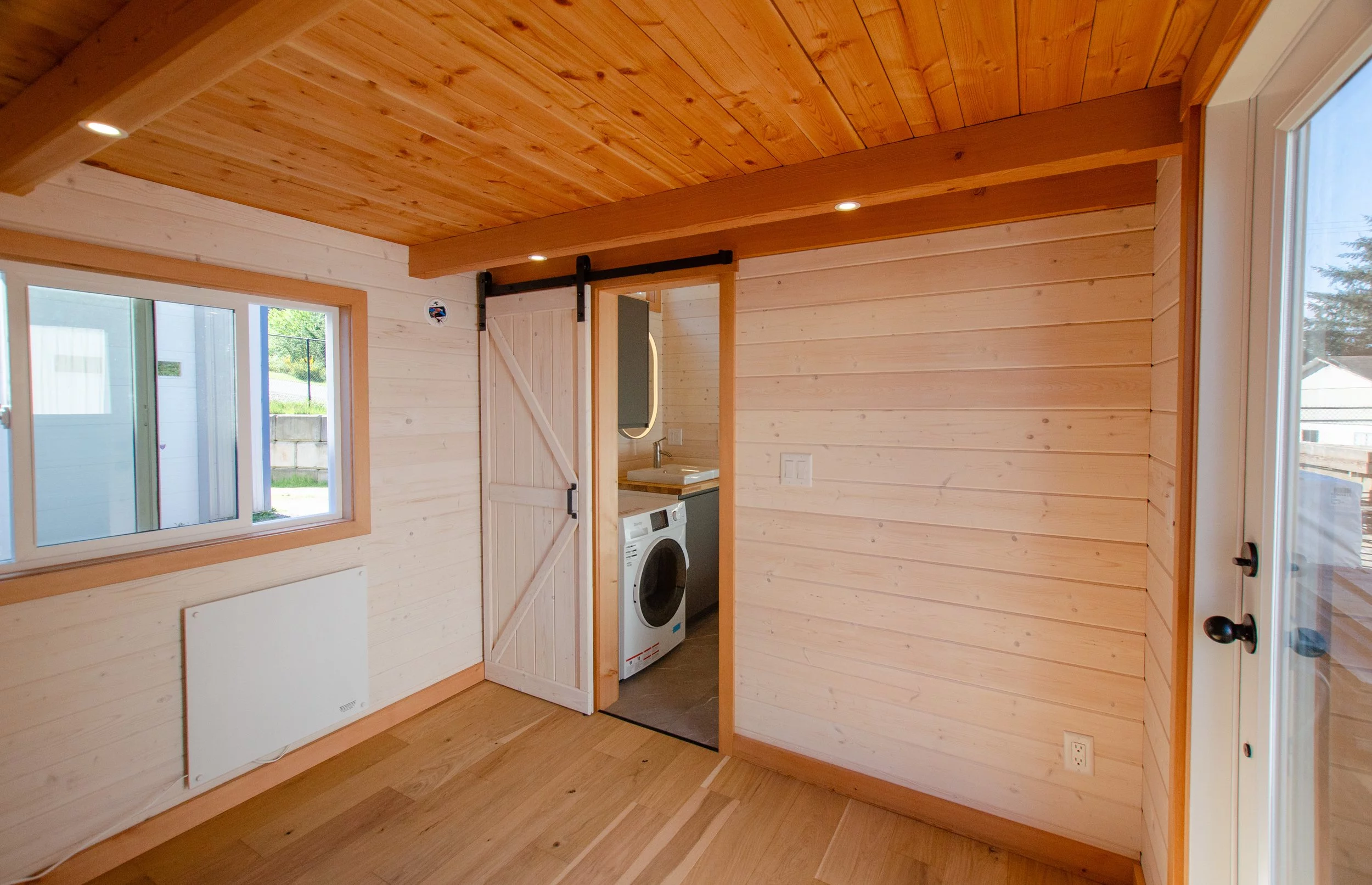 The Juniper's bedroom is accessed from the bathroom by barn-style sliding door