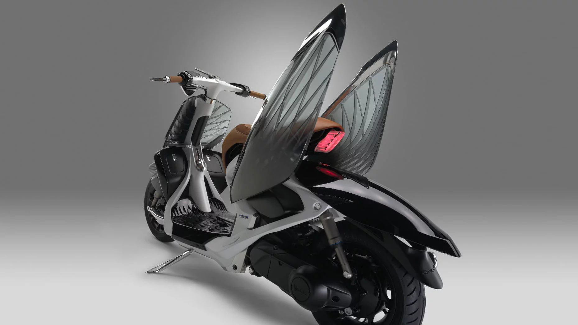 Lifting the side panels of the Yamaha 04Gen provides access to the scooter's inner workings and gives it a distinct dragonfly look