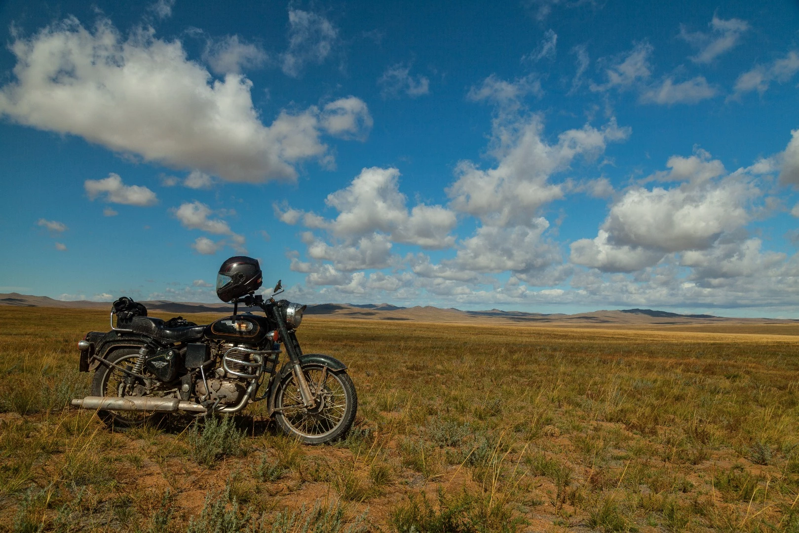 The venerable Bullet 500 in the endless Mongolian steppe. I gave this thing merry hell for two weeks. I managed to smash off the sidestand spring and clog the air filter up with gunk, and bent the brake lever up against the exhaust, but our mechanic Gufram sorted it out with a rock and a steel tube. Between Tsaaganuur and Ayag nuur