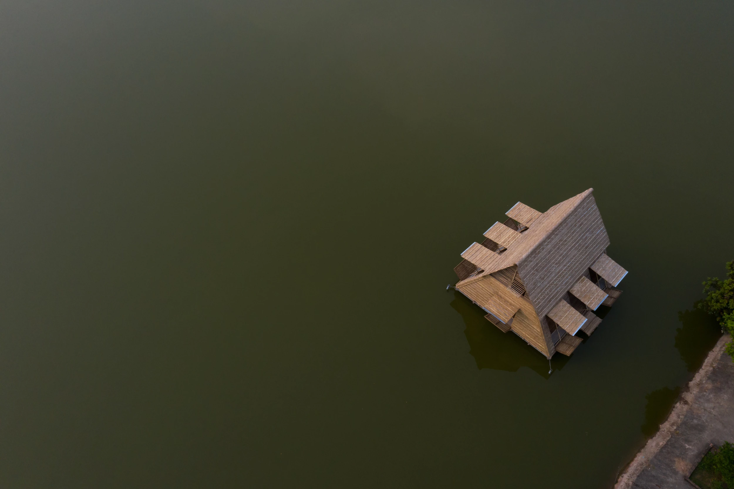The Floating Bamboo House floats on plastic drums attached to its underside
