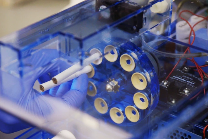 Harvard scientists have developed an instrument that smokes cigarettes in the same way a human does, and runs the smoke through a lung-on-a-chip to model the effects on health