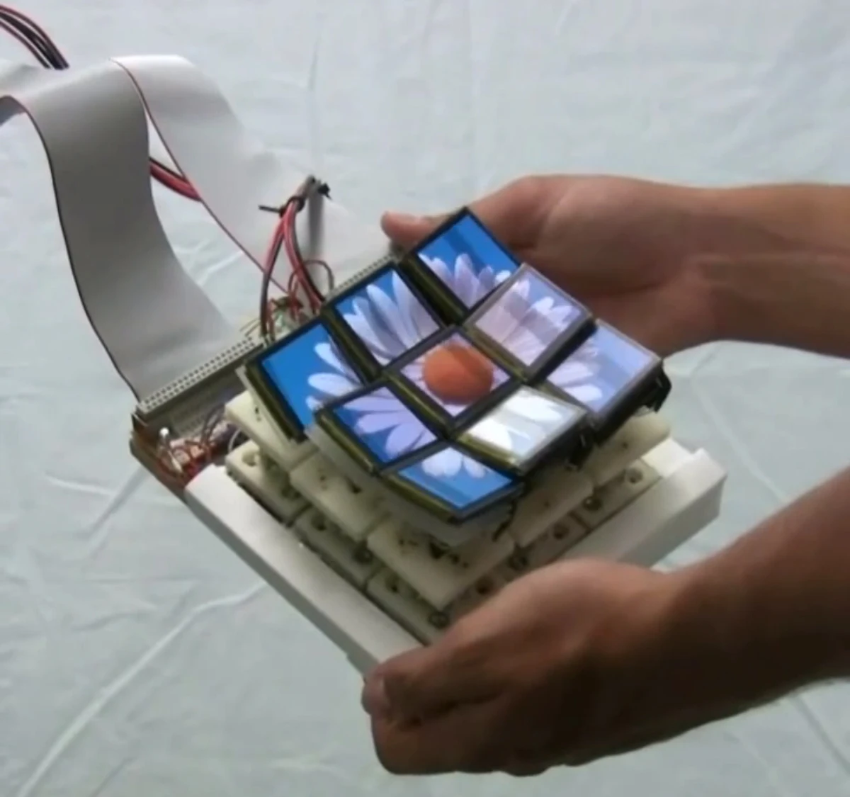 The Tilt Display prototype has nine screen components that move and tilt individually to physically represent what is on screen