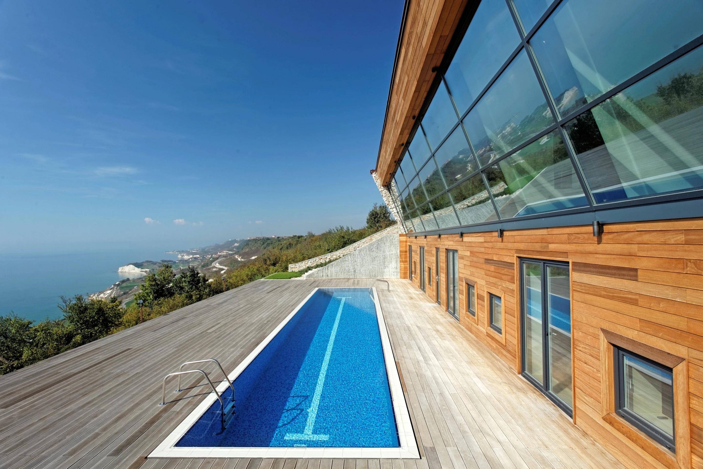 Equinox House's south-facing pool doubles as a reflector, bouncing light into the house (Photo: Ignatov Architects)