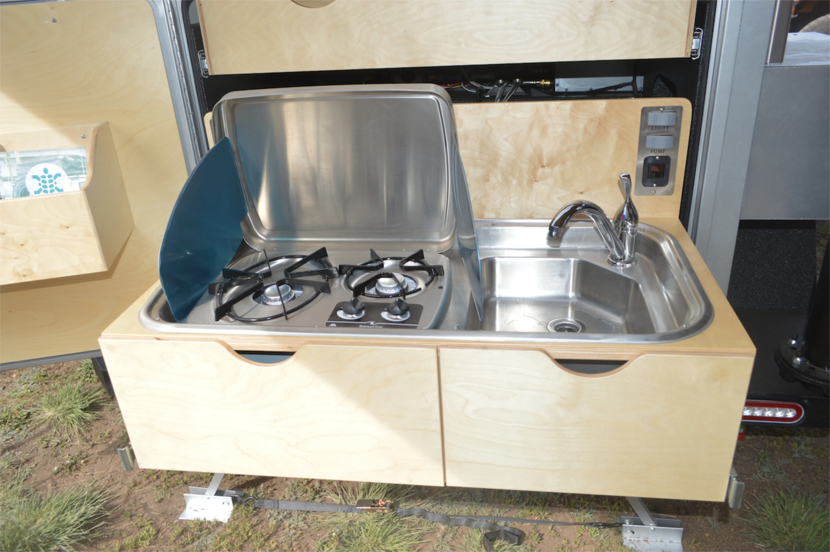 The kitchen area has lower storage drawers