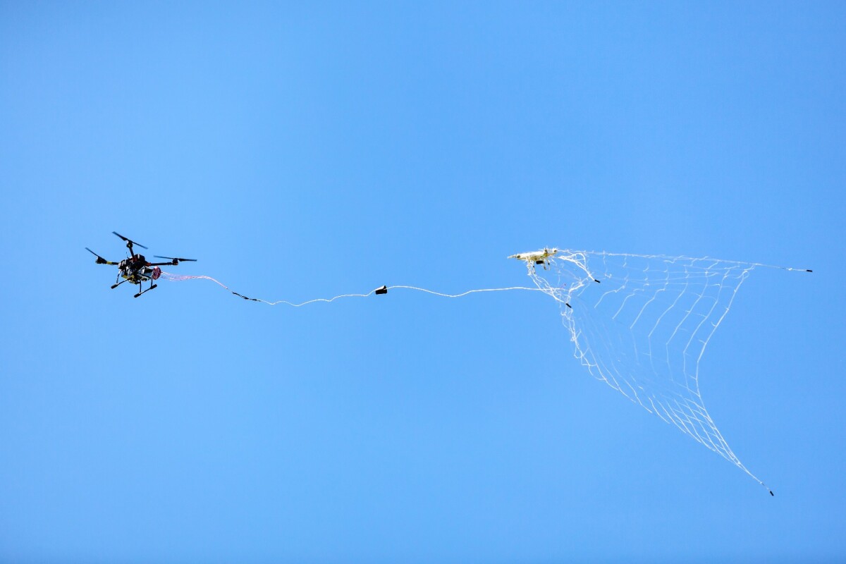 The DroneCatcher uses its pneumatic net gun to shoot a net at an intruding drone from a distance of up to 20 m (66 ft), capturing it