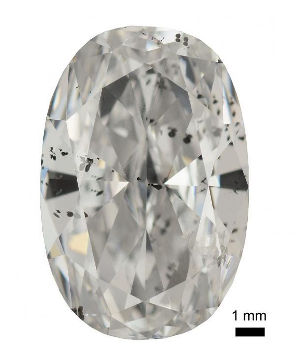 A cut and polished diamond with metallic inclusions – the most obvious group of inclusions looks like black spots on the left side, middle.