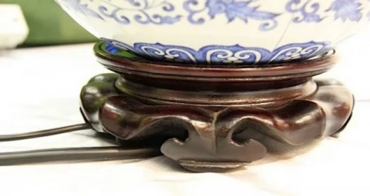 Wires connect from under the wooden stand