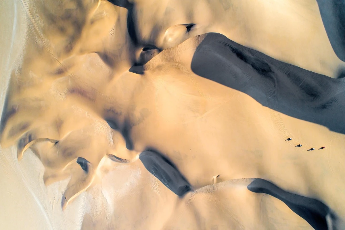 Quad bikes tear through the sand of the Namibian desert