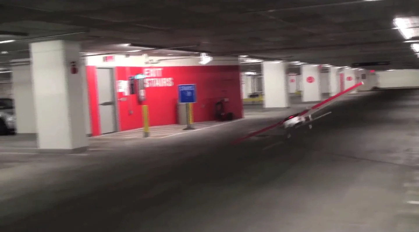 The UAV flies through a multi-story car park