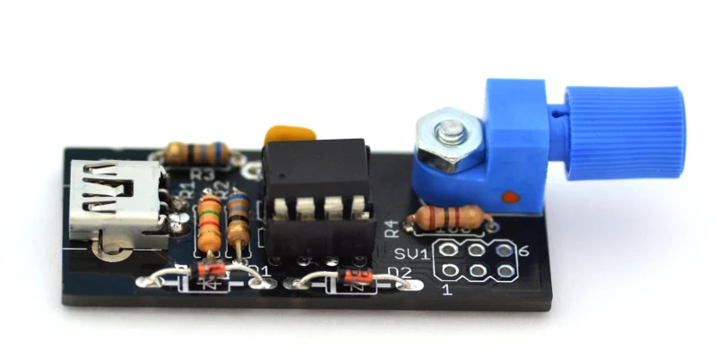 An interrupter connects to the tinyTesla by fiber optic cable and converts polyphonic MIDI audio files from a computer or instrument connected via USB into pulses of light