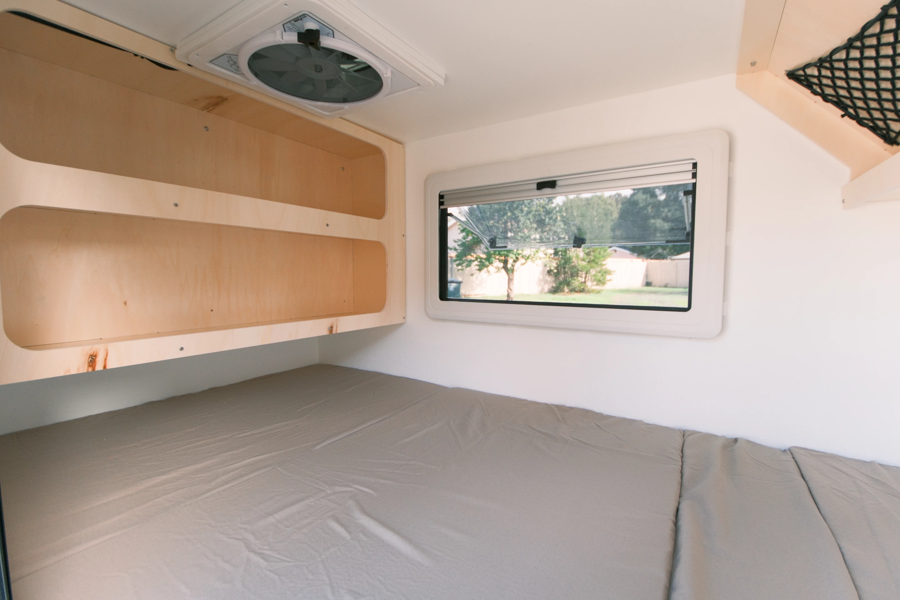 The Unit-1 interior is simple with some upper cubby and overhead net storage