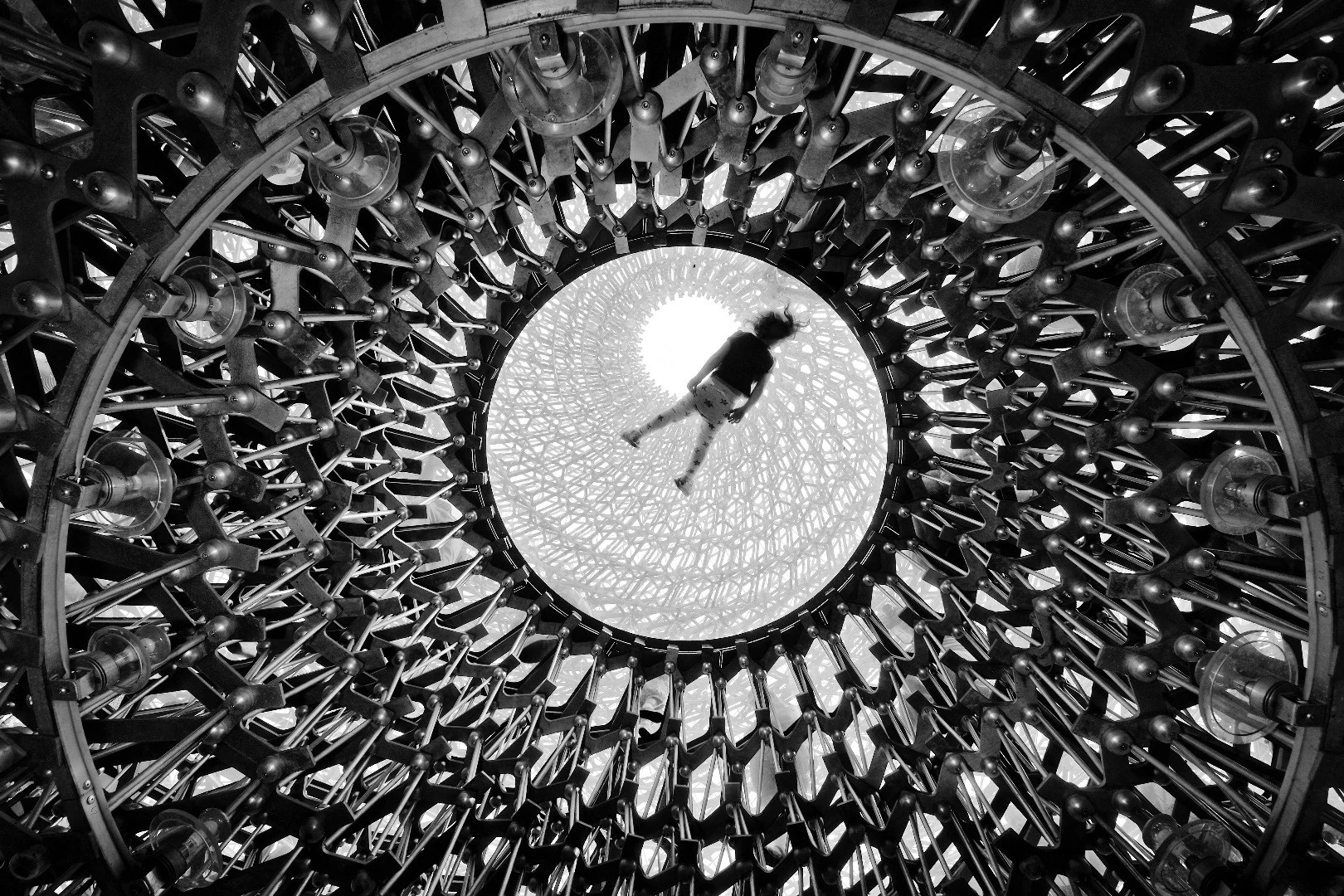 Elevation, by Naf Selmani, was taken in London, UK, using a Fujifilm X-T10. "The Hive - Kew Gardens' spectacular new bee-inspired sculpture seen from below as one of the visitor lays on the top glass floor to pose for pictures. This multi-sensory experience integrates art, science and landscape architecture,” says the photographer