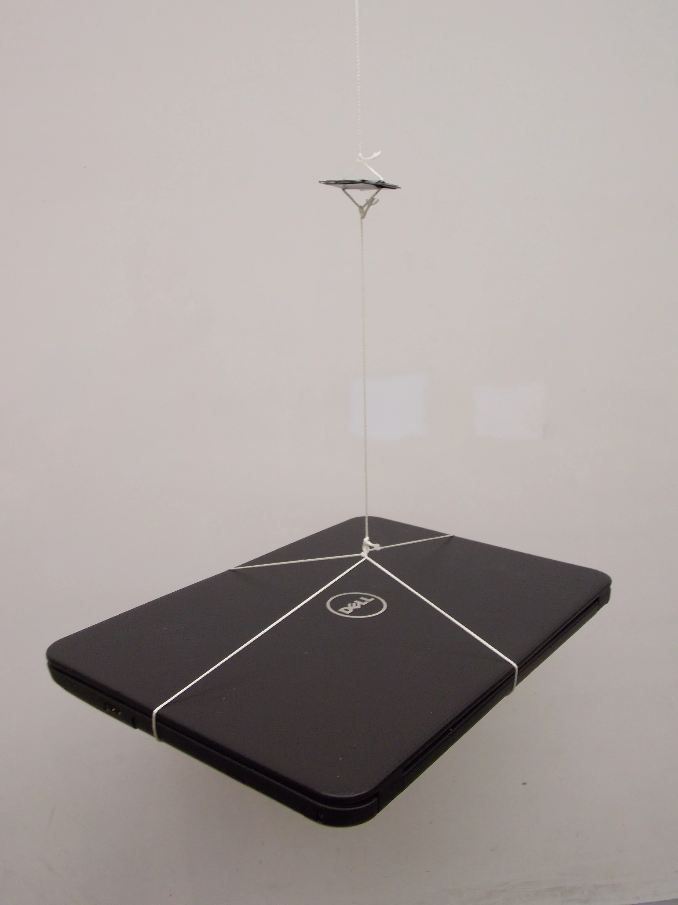 The engineers suspended a heavy laptop from the supercapacitor to demonstrate its strength (Photo: Vanderbilt Nanomaterials and Energy Devices Laboratory)