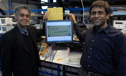 Associate Professor Rahul Sarpeshkar, left, and graduate student Soumyajit Mandal display their RF cochlea (Credit: Donna Coveney/MIT)