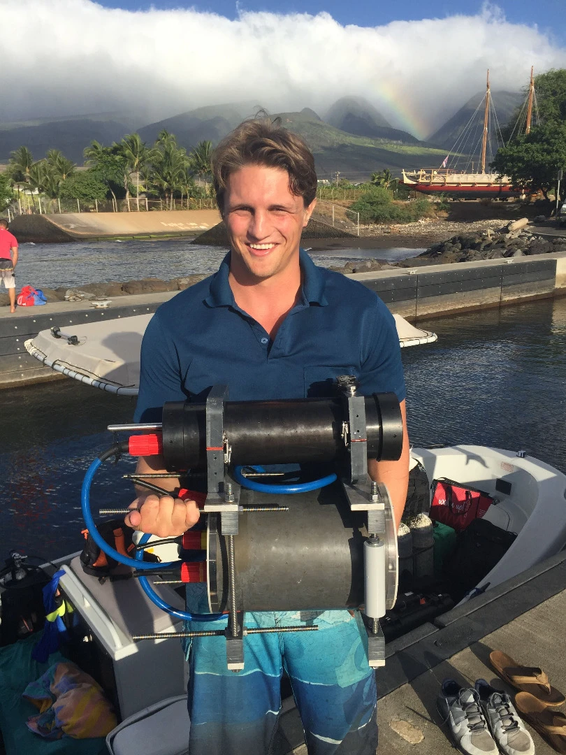 Marine researcher Andrew Mullen holding the Benthic Underwater Microscope