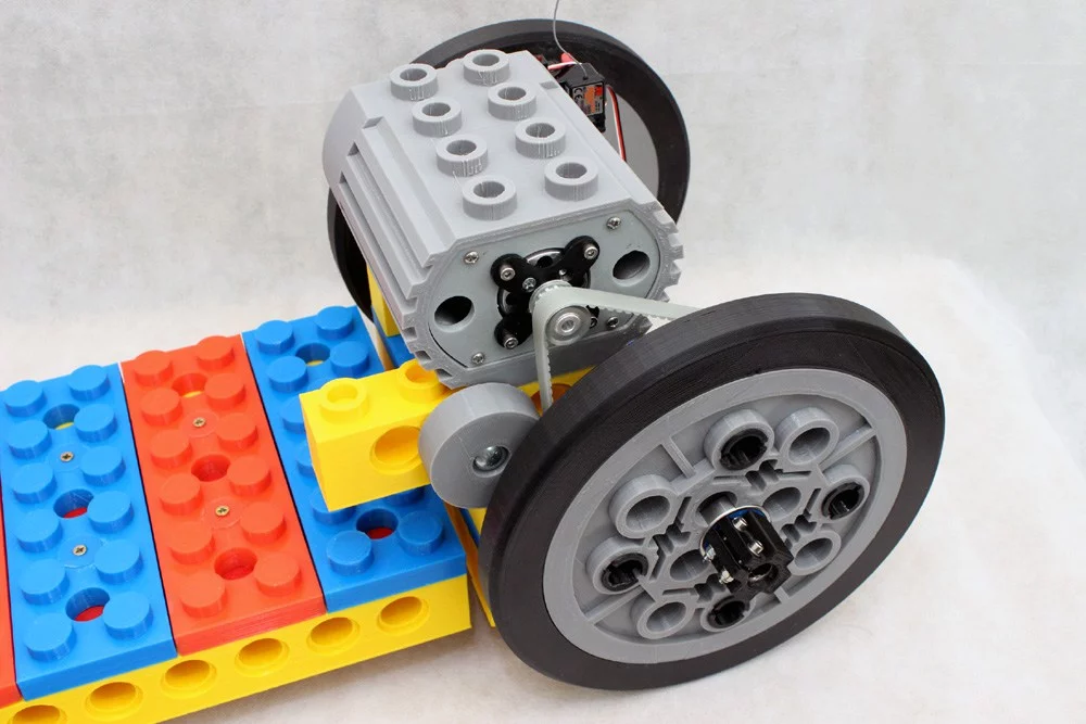 The rear wheel is belt-driven by a Turnigy Aerodrive brushless electric motor