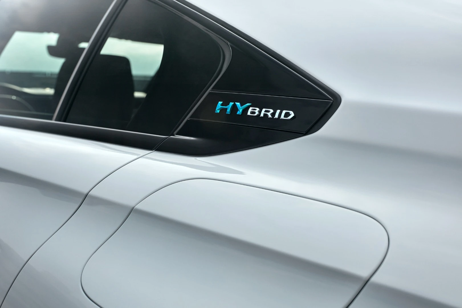 The charging port is located just underneath the "HYbrid" logo on the Peugeot 508