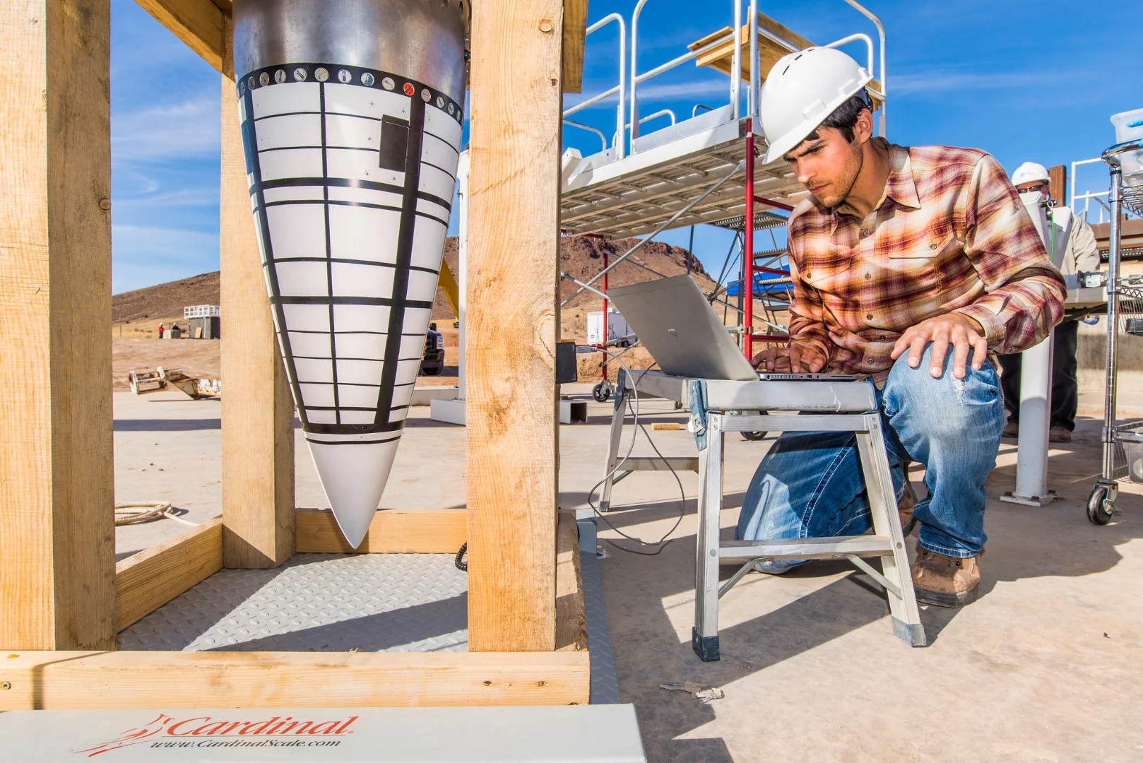 Lead Engineer Tyler Keil with the mock warhead