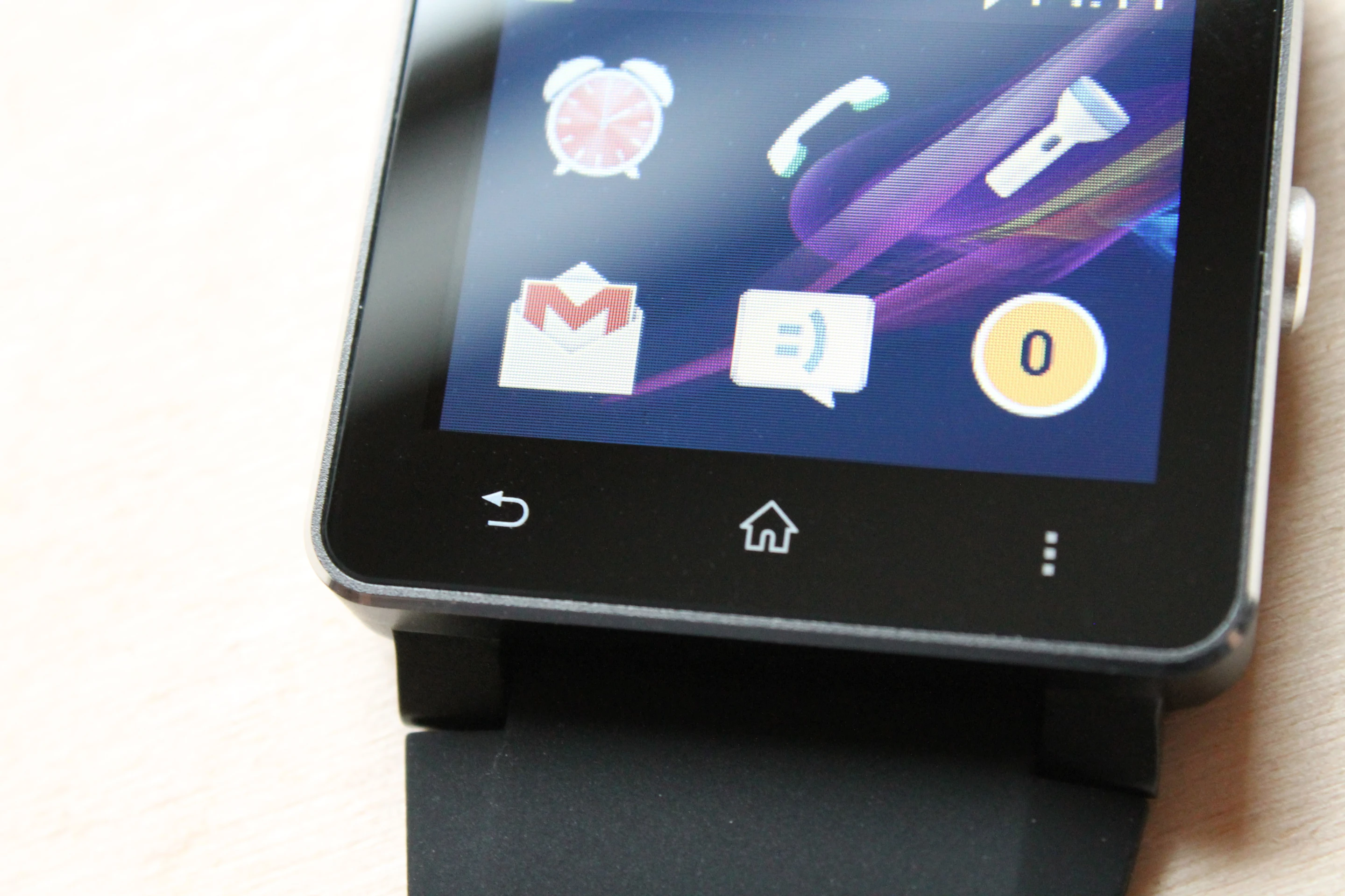 The device features capacitive back, home, and menu keys below the screen