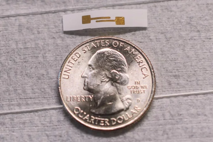 A prototype of the biosensor, with a US quarter for scale