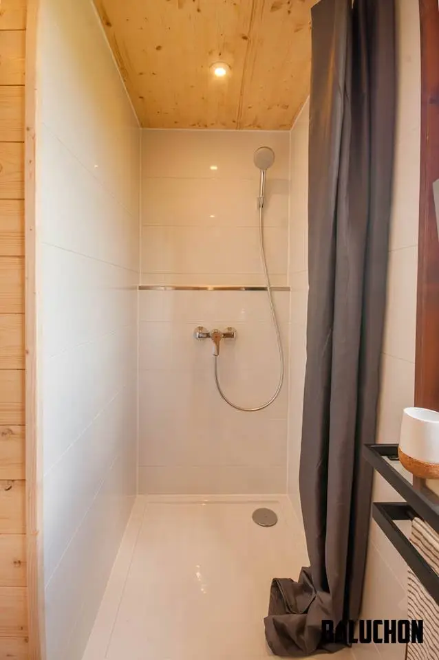 The Pampille's bathroom includes a shower, toilet and storage space