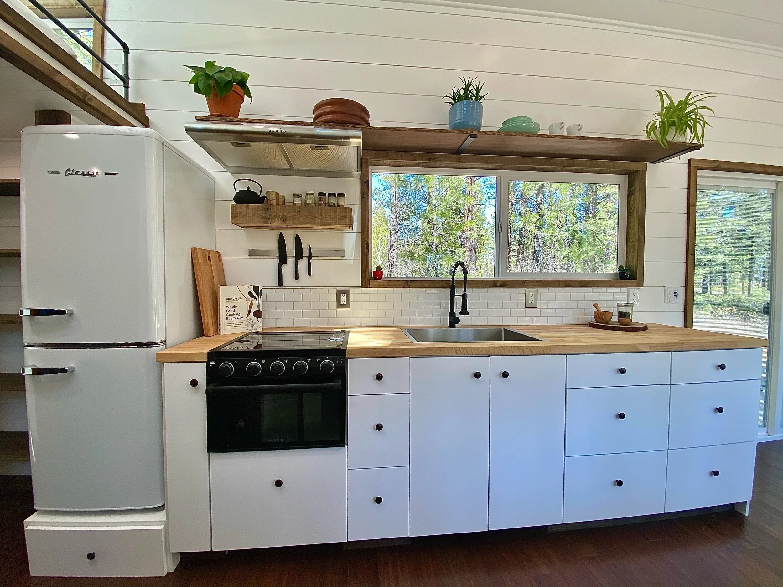 The Sonoma's kitchen includes an oven, three burner propane-powered cooktop, fridge/freezer, and a sink