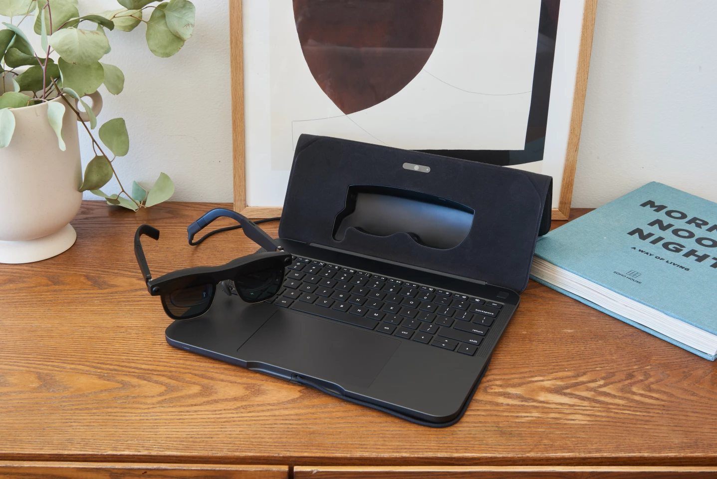 The AR glasses are cabled to, and powered by, the keyboard base