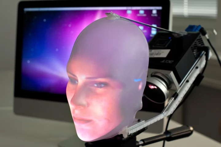 Mask-bot uses a small projector to beam the image of a face onto a transparent plastic mask