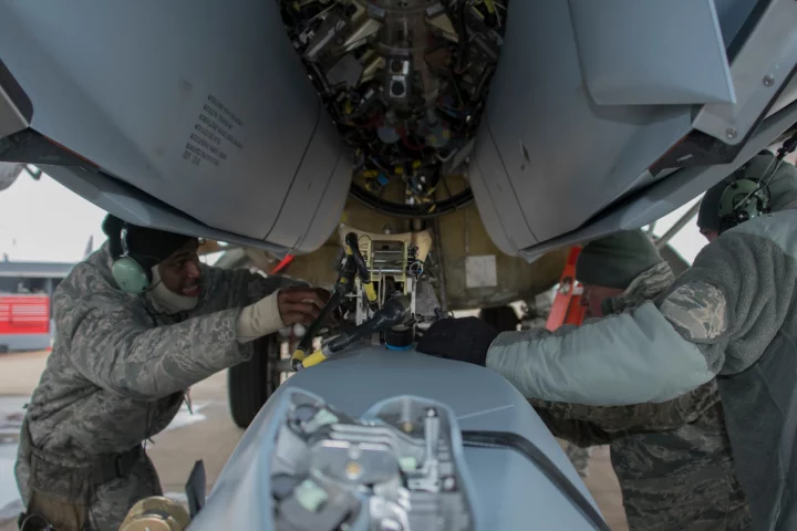 Aircraft armament systems specialists assigned to the 307th Aircraft Maintenance Squadron unload a AGM-158 Joint Air-to-Surface Standoff Missile from a Conventional Rotary Launcher