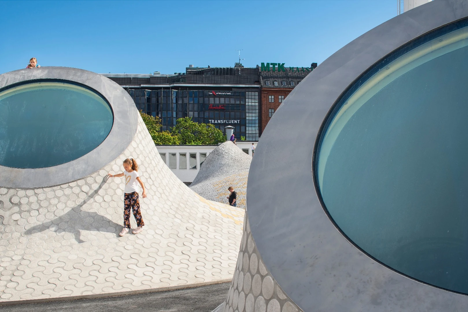 A child plays in the new Lasipalatsi Square in Helsinki