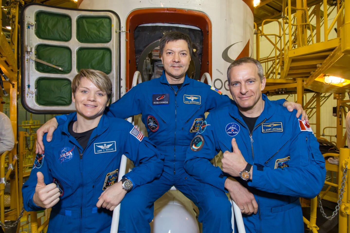 Anne McClain of NASA (left), Oleg Kononenko of Roscosmos (center) and David Saint-Jacques of the Canadian Space Agency (right)