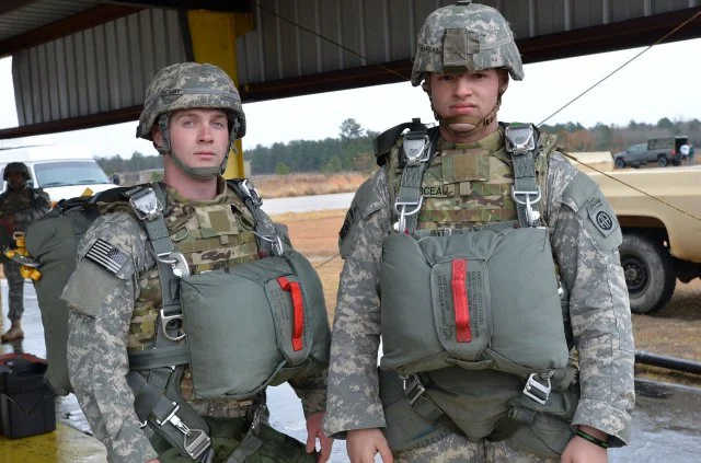 Paratroopers in T-11 parachutes and teh IOTV armored vest