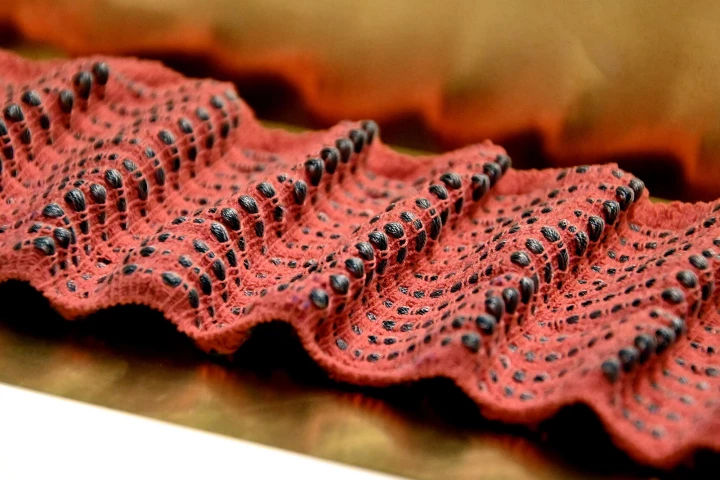 A piece of OminFiber-enabled fabric, with the smart fibers visible in black