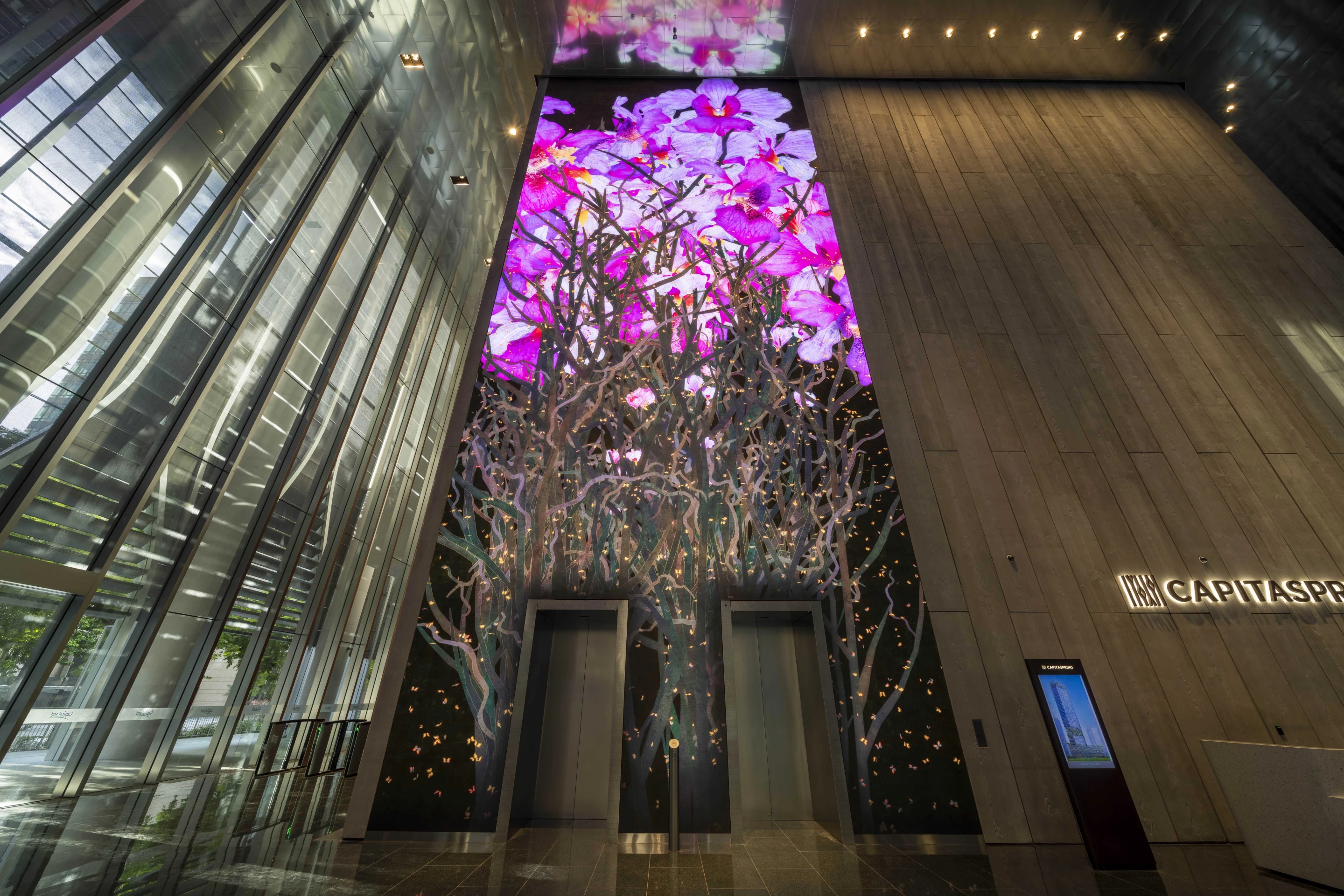 CapitaSpring includes several artworks, such as this 18 m (59 ft) media wall by international art collective teamLab