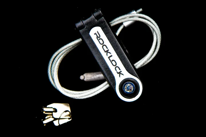 The Rock Lock loops a steel cable through any solid fixture or heavy equipment and then secures a guitar to it courtesy of a locking mechanism around the neck