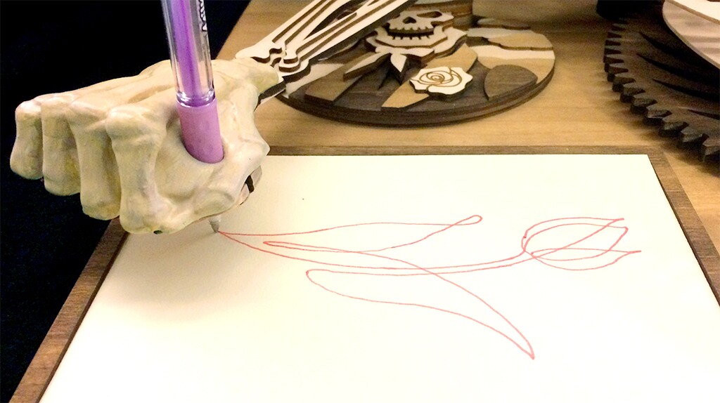 The Drawmaton will need a pen slotted into its drawing arm before its small gear is operated by hand to set the sketching off