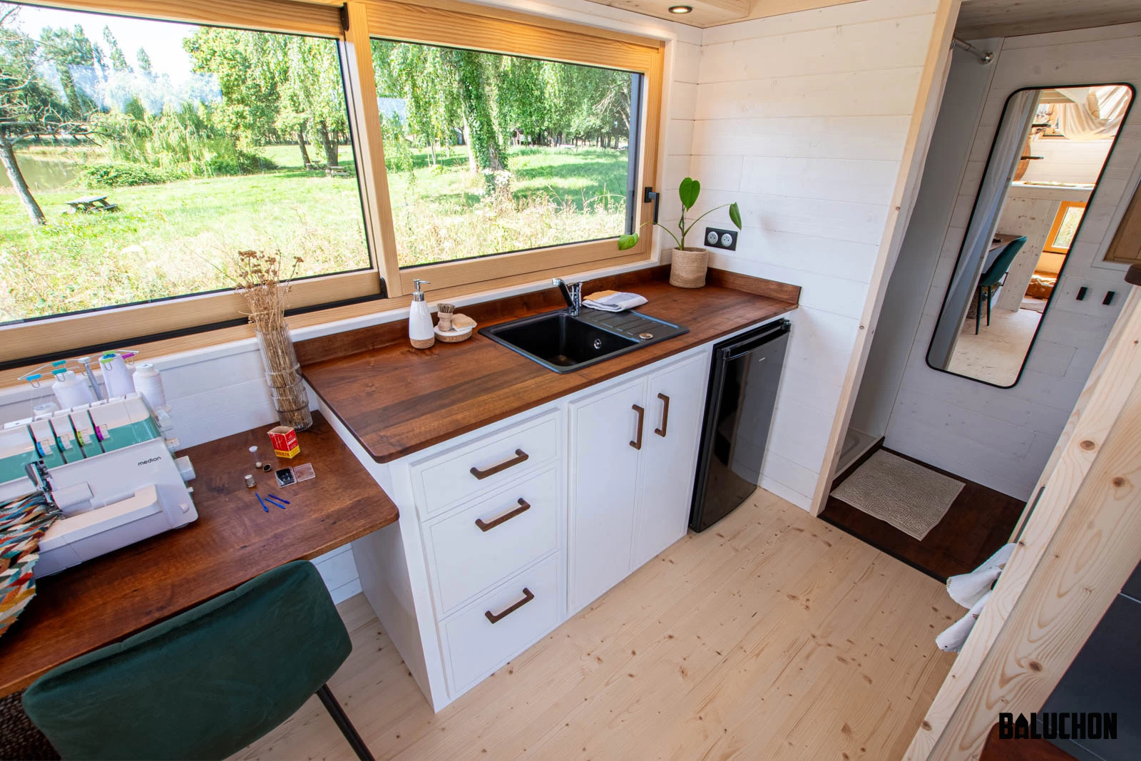 The Nouvelle Dans' kitchen has quite a lot of cabinetry and shelving for its size