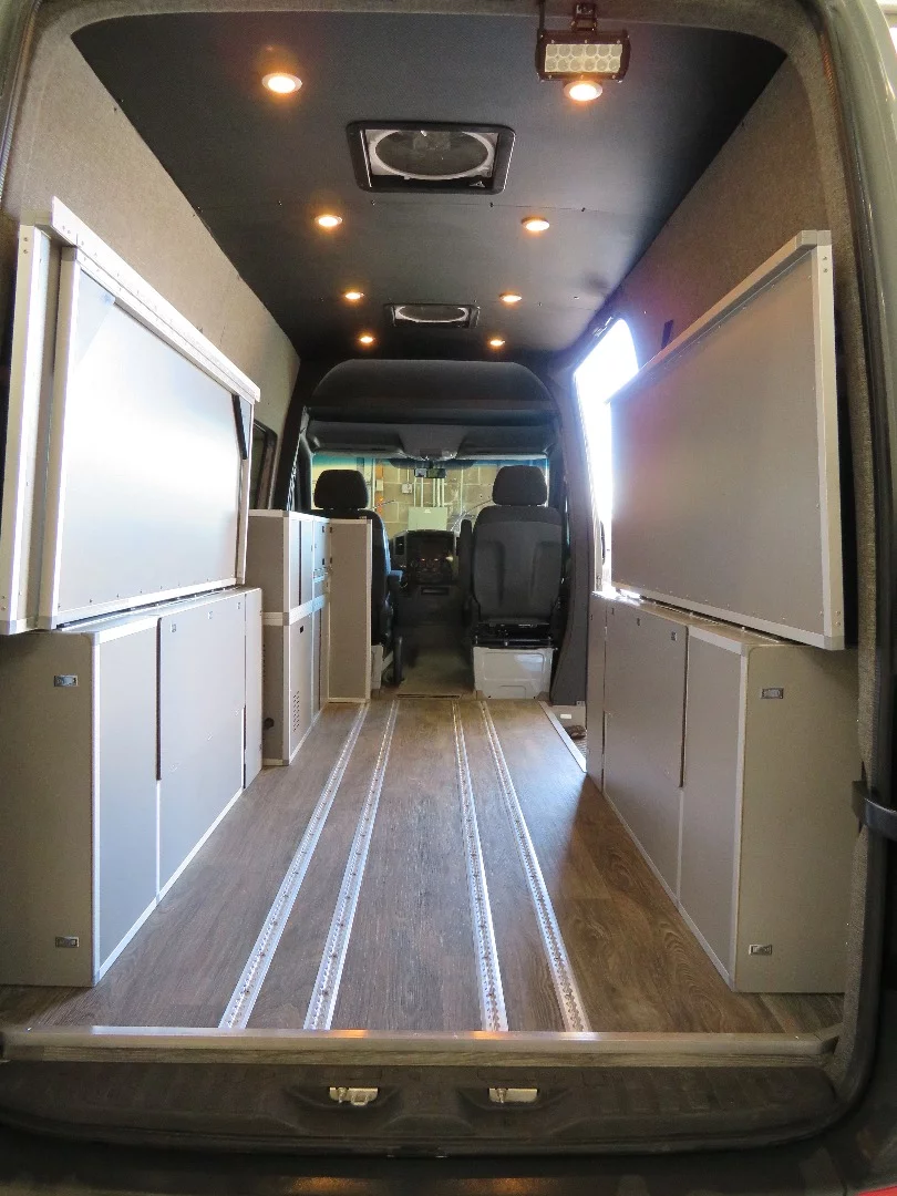 Terracamper's dual-sided Sprinter bed folds away to create plenty of cargo space