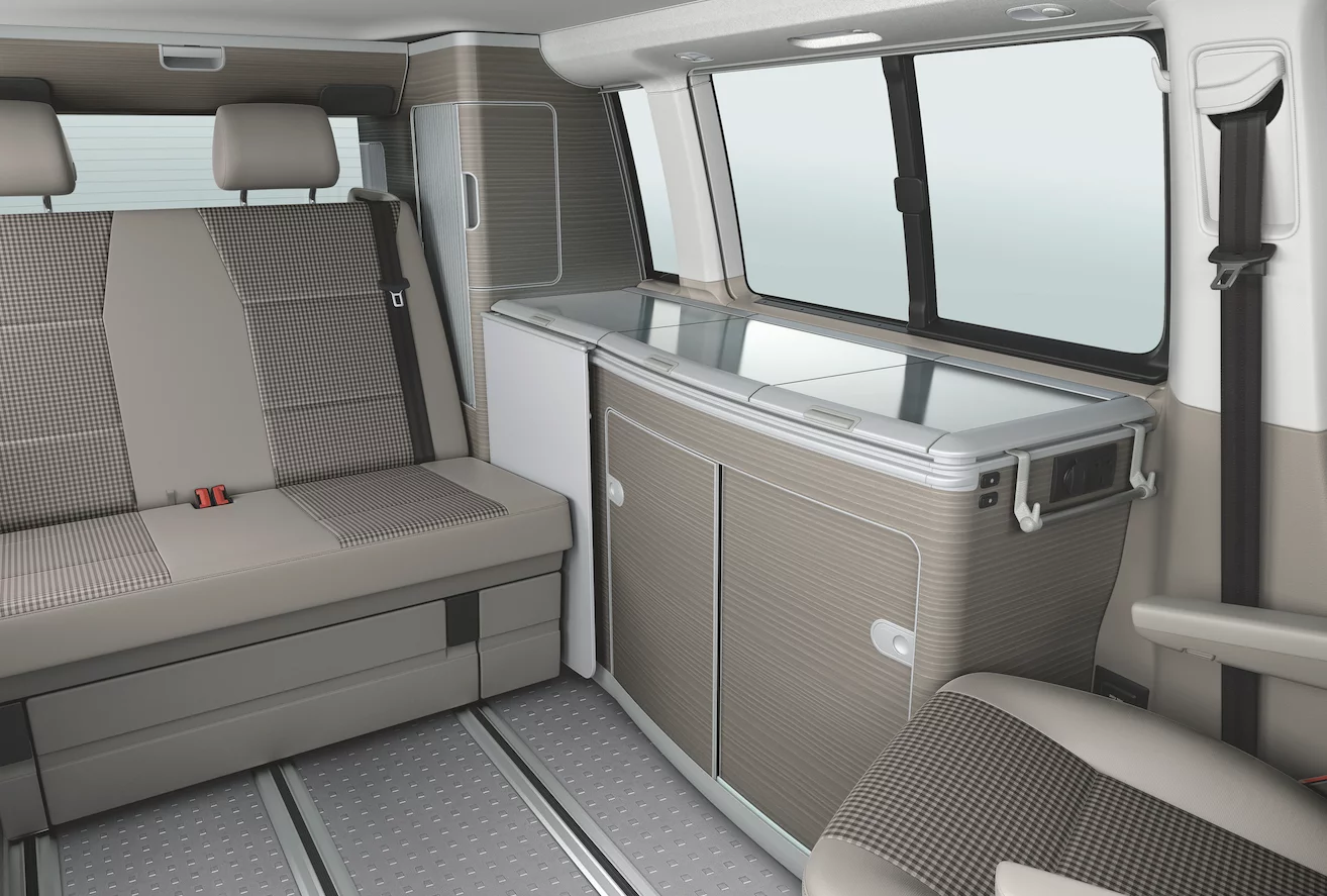 Inside, the VW California 30 Years has a kitchen and cabinetry done in a "bright wood" motif