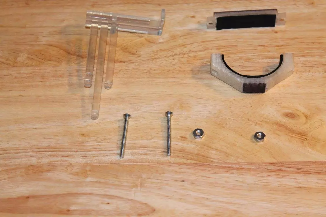 The chord insert (top left) slides onto the top plate (top right) when the system is mounted at the nut of a guitar